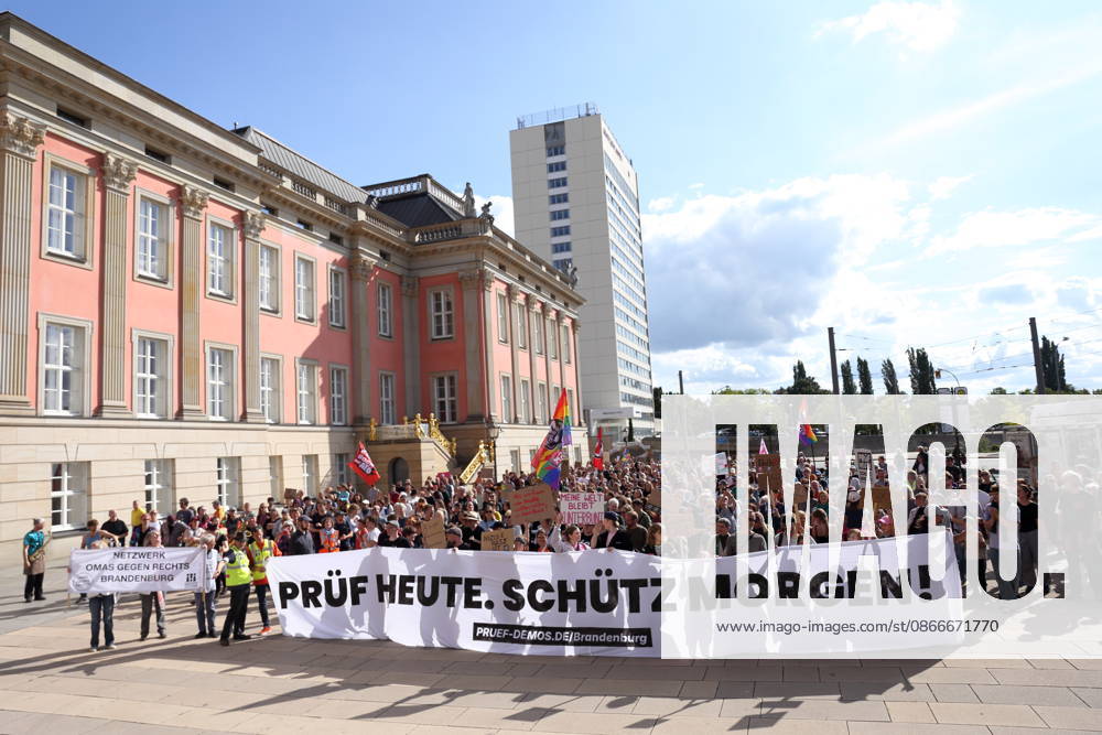 Protesters carrying a banner reading Review today, Schütz tomorrow march around the state parliament during a demonstration calling for the Federal Constitutional Court to review far-right parties, Alter Markt, Potsdam, September 12, 2026. Review demonstration in Potsdam