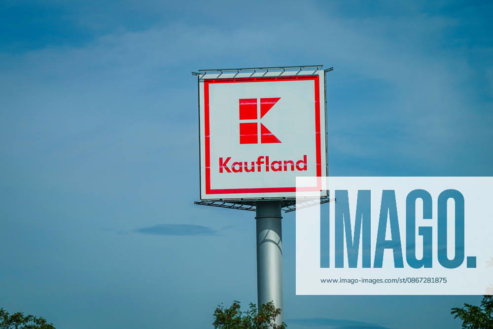 Kaufland advertising sign with company logo and lettering against a blue sky; Kaufland, logo, company logo, lettering, advertising sign, advertising, retail, grocery retail, supermarket, consumer market, discount store, retail group, Schwarz Group, food, shopping, consumption, consumers, trade, economy, company, brand, store, retail chain, stock photo, exterio