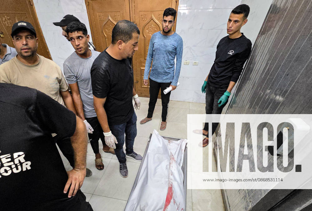 Body of Palestinian Killed in Khan Younis Strike Taken to Nasser Medical Complex Palestinians carry the body of 36-year-old Moaz Jamal Abu Nusaira to Nasser Medical Complex on October 4, 2026, after he was killed in an Israeli airstrike that targeted him north of Khan Younis, in the southern Gaza Strip. Photo by Tariq Mohammad APA Images Khan Yunis Gaza Strip Palestinian Territory 041026_Khan_Yunis_TM_00(5)