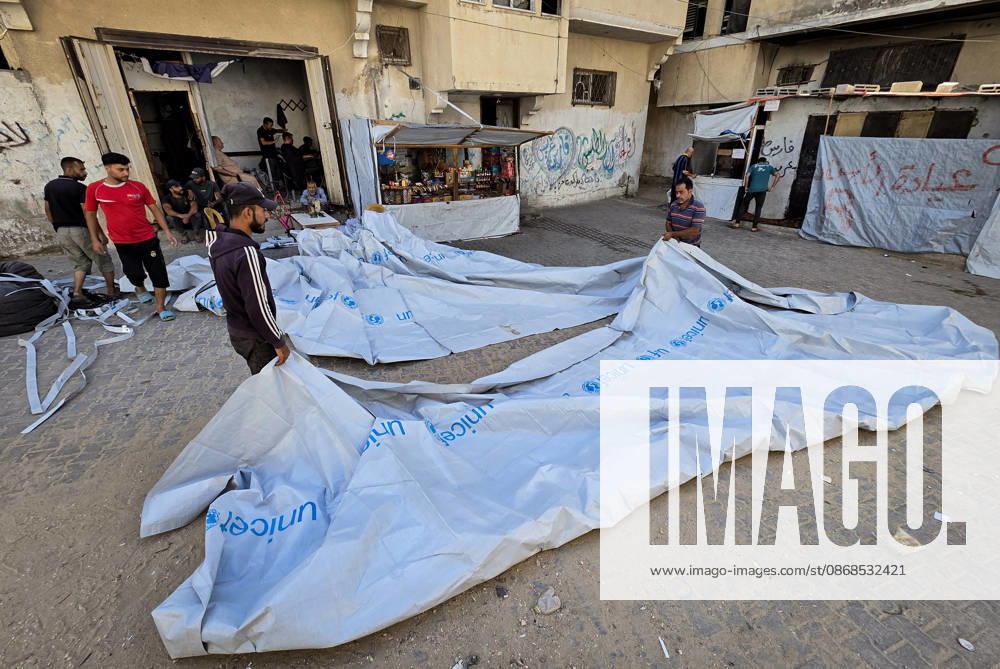 Palestinian Tailor Repairs Tent Covers for Displaced Families in Khan Younis Palestinian tailor Shaaban al-Tabash repairs and assembles tarpaulins and plastic sheets using rudimentary methods to reinforce the tents of displaced Palestinians and protect them from cold weather and rain in Khan Younis, in the southern Gaza Strip, on October 4, 2026. As winter approaches, shortages of protective supplies and the deterioration of many tents after nearly three years of war are worsening living conditions, while al-Tabash uses available materials to extend the life of shelters that have become the last refuge for thousands of displaced people. Photo by Tariq Mohammad APA Images Khan Yunis Gaza Strip Palestinian Territory 041026_Khan_Yunis_TM_01(