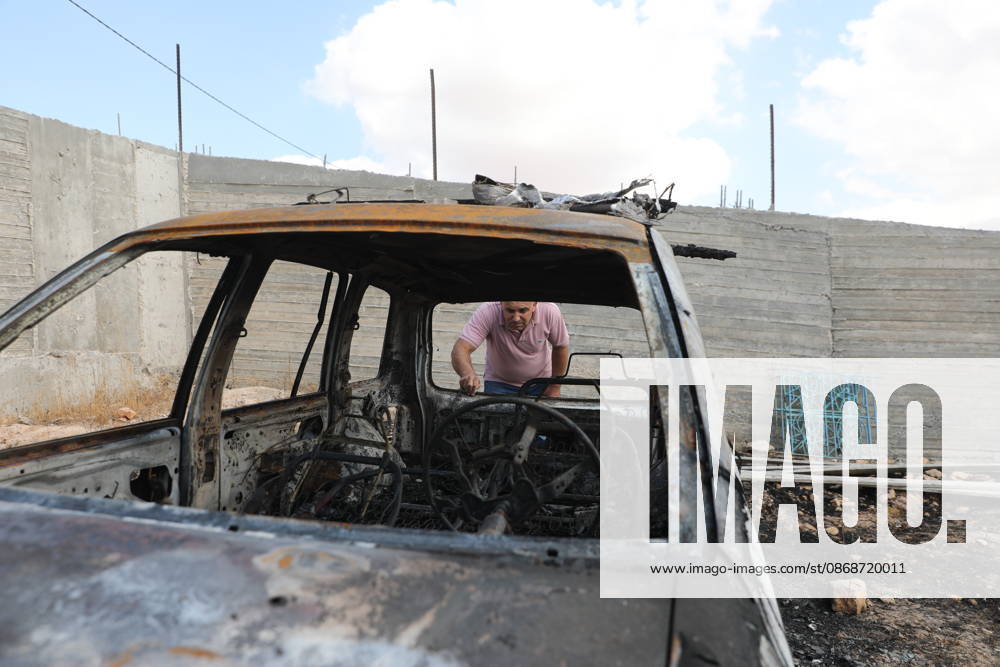 Palestinian Inspects Burned Vehicles Near al-Samu South of Hebron A Palestinian man inspects his burned vehicles near the town of al-Samu, south of Hebron, in the West Bank, on October 6, 2026, after an apparent arson attack believed to have been carried out by Israeli settlers. The incident comes amid an increase in settler attacks on Palestinians and their property in different areas of the West Bank. Photo by Mamoun Wazwaz apaimages Hebron West Bank Palestinian Territory 061026_Hebron_MW_00(6)