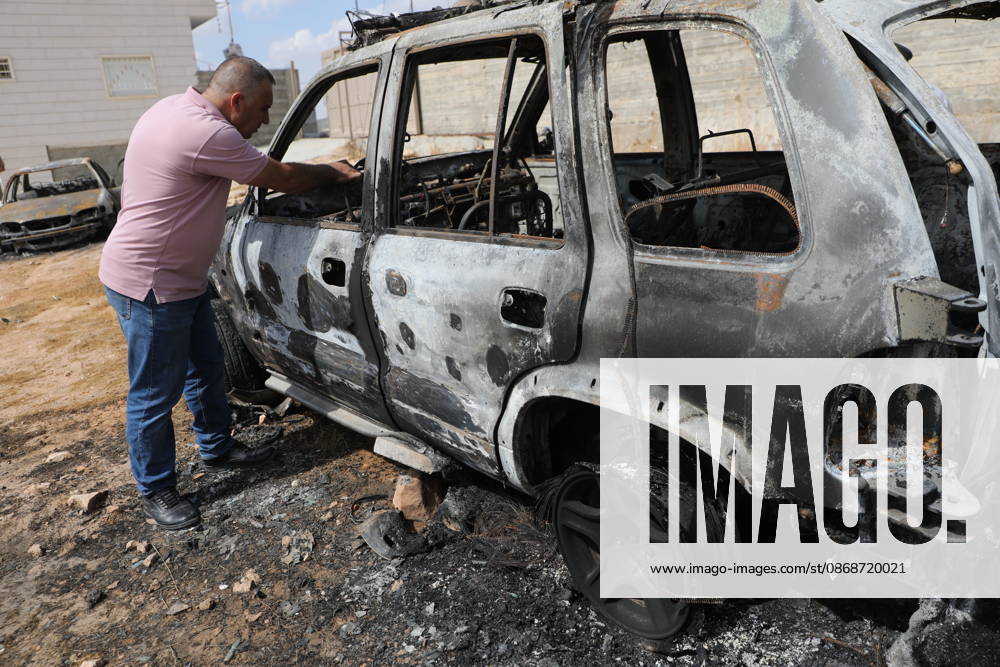 Palestinian Inspects Burned Vehicles Near al-Samu South of Hebron A Palestinian man inspects his burned vehicles near the town of al-Samu, south of Hebron, in the West Bank, on October 6, 2026, after an apparent arson attack believed to have been carried out by Israeli settlers. The incident comes amid an increase in settler attacks on Palestinians and their property in different areas of the West Bank. Photo by Mamoun Wazwaz apaimages Hebron West Bank Palestinian Territory 061026_Hebron_MW_00(12)