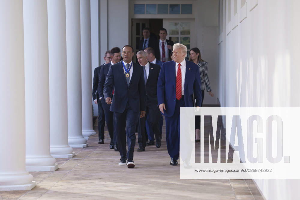 U.S. President Donald Trump walks with golfer Tiger Woods along the West Colonnade of the White House before a reception honoring Black History Month, February 20, 2025 in Washington, D.C. Woods, who received the Presidential Medal of Freedom from Trump in 2019, joined PGA Tour leaders at the White House for talks on a proposed deal with Saudi Arabiaâ€⠢s Public Investment Fund before Trump introduced him as a surprise guest at a Black History Month reception. Washington United States of America - ZUMAp138 20261006_zaa_p138_001