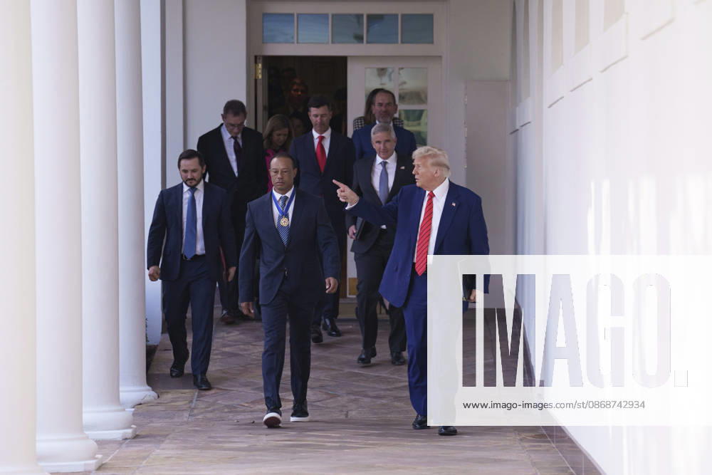 U.S. President Donald Trump walks with golfer Tiger Woods along the West Colonnade of the White House before a reception honoring Black History Month, February 20, 2025 in Washington, D.C. Woods, who received the Presidential Medal of Freedom from Trump in 2019, joined PGA Tour leaders at the White House for talks on a proposed deal with Saudi ArabiaÃ¢â‚¬â ¢s Public Investment Fund before Trump introduced him as a surprise guest at a Black History Month reception. Washington United States of America - ZUMAp138 20261006_zaa_p138_006