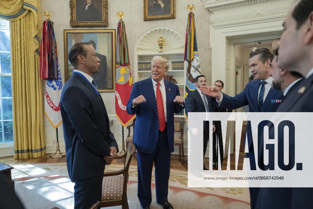 U.S. President Donald Trump speaks with golfer Tiger Woods and officials in the Oval Office of the White House, February 20, 2025 in Washington, D.C. Woods, who received the Presidential Medal of Freedom from Trump in 2019, joined PGA Tour leaders at the White House for talks on a proposed deal with Saudi Arabiaâ€⠢s Public Investment Fund before Trump introduced him as a surprise guest at a Black History Month reception. Washington United States of America - ZUMAp138 20261006_zaa_p138_004
