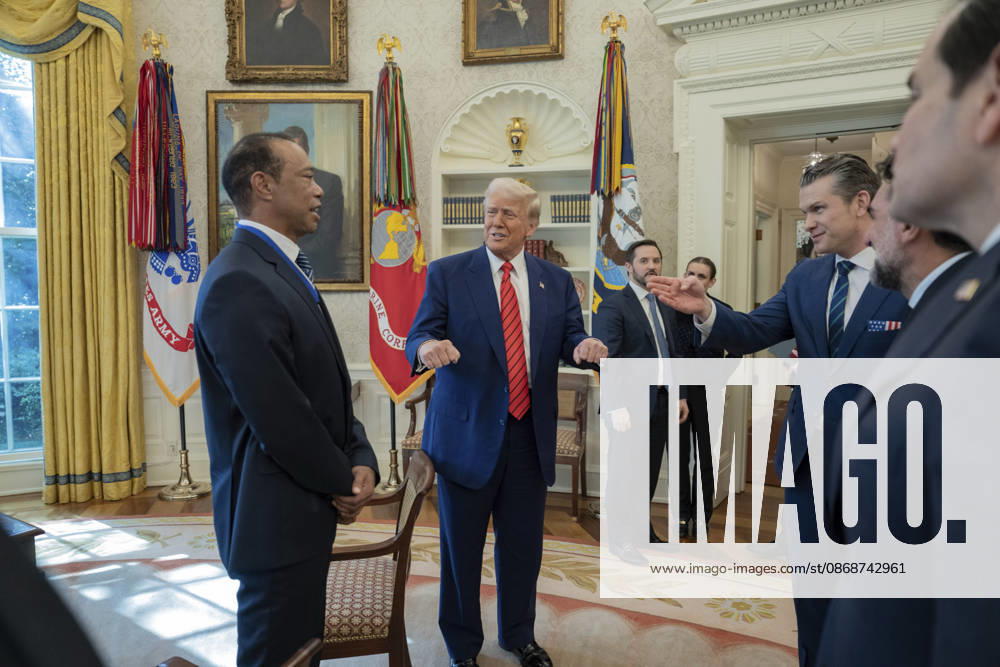 U.S. President Donald Trump speaks with golfer Tiger Woods and officials in the Oval Office of the White House, February 20, 2025 in Washington, D.C. Woods, who received the Presidential Medal of Freedom from Trump in 2019, joined PGA Tour leaders at the White House for talks on a proposed deal with Saudi Arabiaâ€⠢s Public Investment Fund before Trump introduced him as a surprise guest at a Black History Month reception. Washington United States of America - ZUMAp138 20261006_zaa_p138_012
