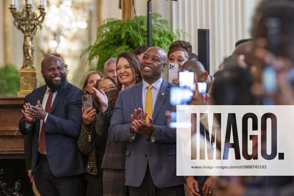 U.S Senator Tim Scott, R-SC, center, and Secretary of Agriculture Brooke Rollins, left, applaud President Donald Trump during a Black History Month event at the East Room of the White House, February 20, 2025 in Washington, D.C. Washington United States - ZUMAp138 20261006_zaa_p138_020