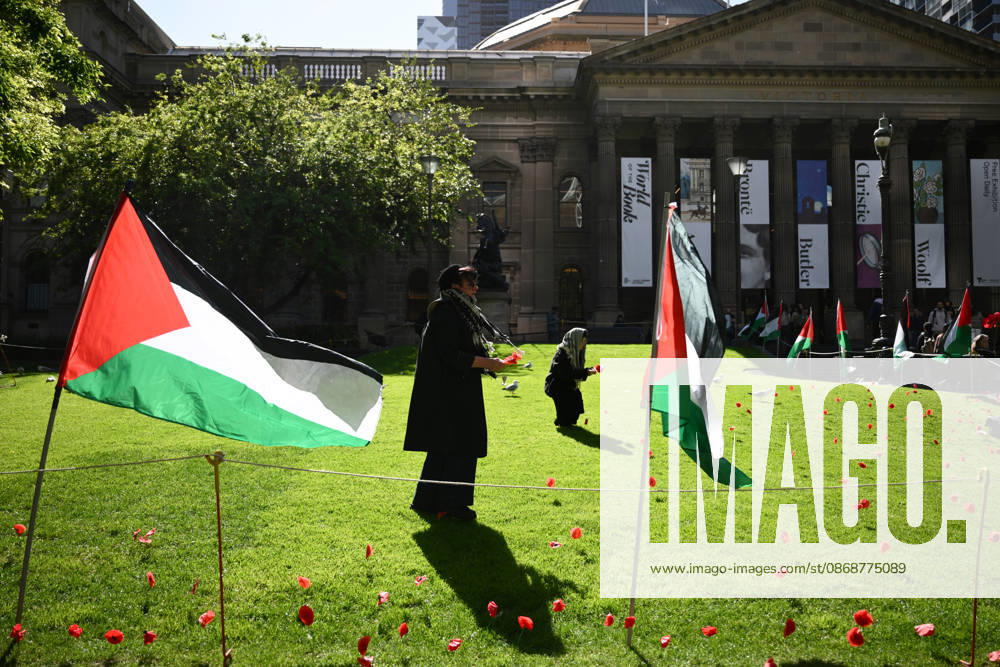 PRO-PALESTINE VIGIL, Pro-Palestine protestors places poppies on the lawn during a vigil for Gaza at the State Library Victoria in Melbourne, Wednesday, October 7, 2026. ( NO ARCHIVING MELBOURNE VICTORIA Australia