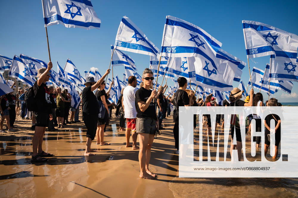 Activists carry flags at the beach in protest against the Israeli government on the third anniversary of October 7th. Tel Aviv Israel - ZUMAg280 20261007_znp_g280_009
