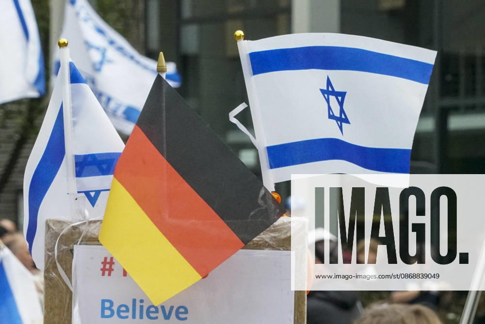CNTV VIGIL: Demonstrators on the street; participants holding German and Israeli flags at the vigil marking the third anniversary of the attack and massacre in Israel; people gathering in front of the Audimax in the Grindelviertel neighborhood of Hamburg on October 7, 2026, Hamburg, Germany