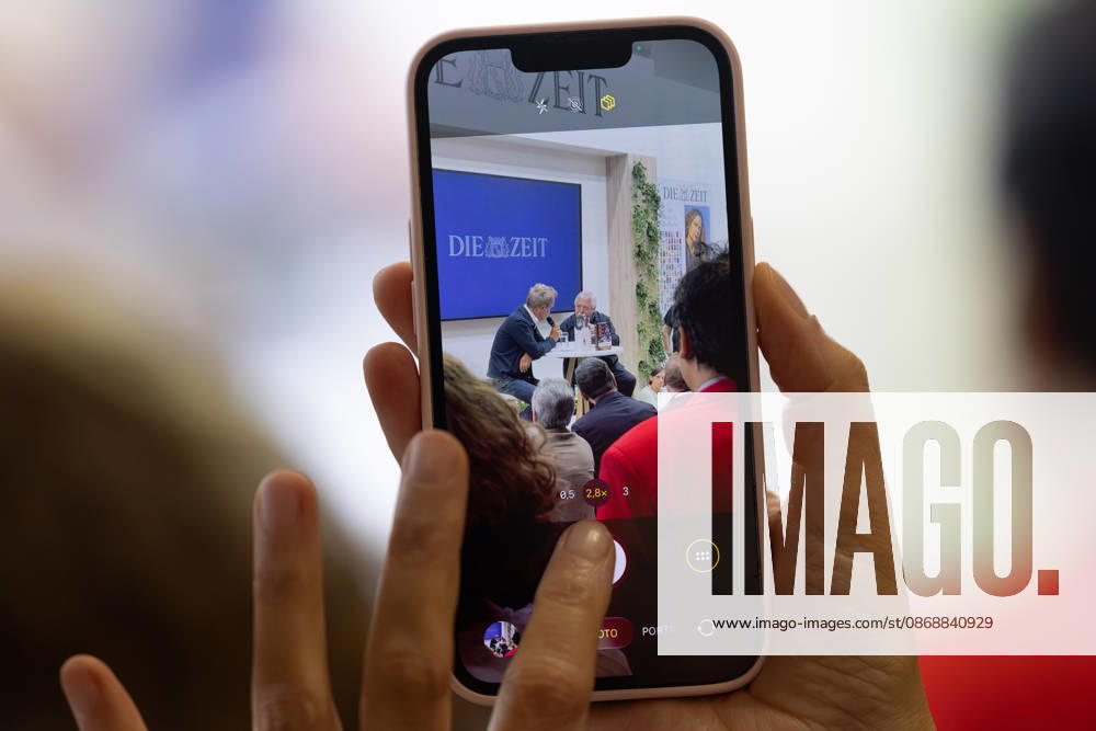 Frankfurt Book Fair 2026: A visitor to the book fair films Wolf Biermann as he talks with *ZEIT* editor Volker Weidermann about excerpts from his diaries and his eventful life, Frankfurt am Main, Hesse, Germany, Exhibition Center
