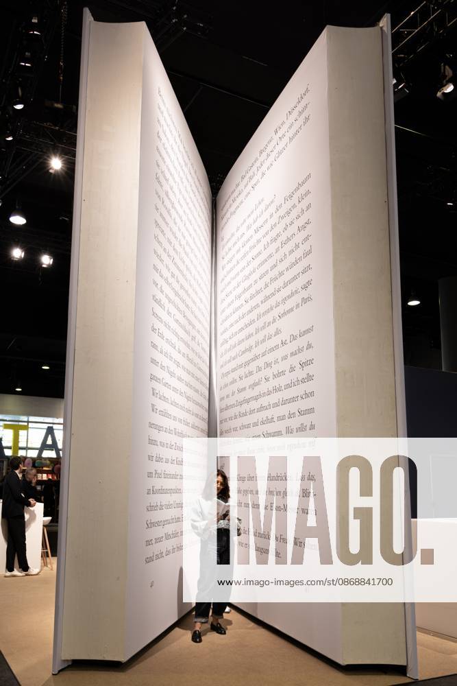 78th Frankfurt Book Fair: A visitor to the Frankfurt Book Fair reads a book inside a giant model of a book. The 78th Frankfurt Book Fair will take place October 7–11, 2026, at the Frankfurt am Main Exhibition Center in Hesse, Germany. 2026-10-07_frankfurter-buchmesse_16