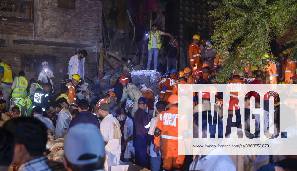 National Disaster Response Force (NDRF) jawans, Delhi Fire Service personnel, and local residents navigate heavy rubble during a search and rescue operation after a four-storey residential building collapsed in the New Seemapuri area of Shahdara on October 7, 2026, in New Delhi, India. The structural collapse occurred around 3:30 PM behind the local fish market, trapping multiple residents under concrete slabs and damaging two adjoining houses. At least one minor died while eight people were rescued and rushed to Rajiv Gandhi Super Speciality Hospital for emergency medical treatment as sniffer dogs and excavators worked late into the evening to locate remaining trapped survivors. (Photo by Raj K Raj Hindustan T