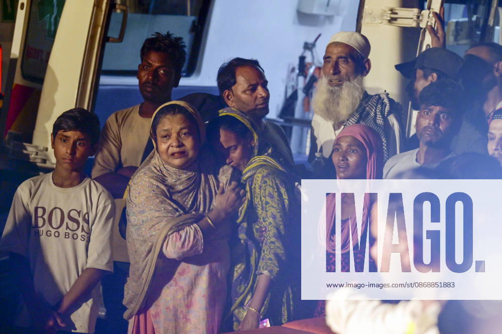 Mourning family members gather at the site where rescue operations are underway after a four-storey residential building collapsed in the New Seemapuri area of Shahdara on October 7, 2026, in New Delhi, India. The structural collapse occurred around 3:30 PM behind the local fish market, trapping multiple residents under concrete slabs and damaging two adjoining houses. At least one minor died while eight people were rescued and rushed to Rajiv Gandhi Super Speciality Hospital for emergency medical treatment as sniffer dogs and excavators worked late into the evening to locate remaining trapped survivors. (Photo by Raj K Raj Hindustan Times) 3 Dead, Eight Injured In 5 Storey Building Collapses In New Seemapuri O