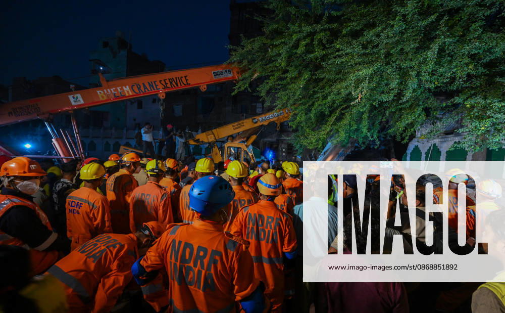 National Disaster Response Force (NDRF) jawans, Delhi Fire Service personnel, and local residents navigate heavy rubble during a search and rescue operation after a four-storey residential building collapsed in the New Seemapuri area of Shahdara on October 7, 2026, in New Delhi, India. The structural collapse occurred around 3:30 PM behind the local fish market, trapping multiple residents under concrete slabs and damaging two adjoining houses. At least one minor died while eight people were rescued and rushed to Rajiv Gandhi Super Speciality Hospital for emergency medical treatment as sniffer dogs and excavators worked late into the evening to locate remaining trapped survivors. (Photo by Raj K Raj Hindustan T