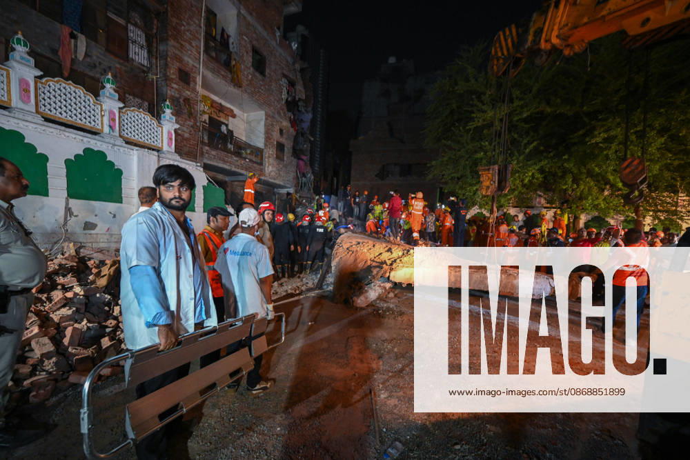 National Disaster Response Force (NDRF) jawans, Delhi Fire Service personnel, and local residents navigate heavy rubble during a search and rescue operation after a four-storey residential building collapsed in the New Seemapuri area of Shahdara on October 7, 2026, in New Delhi, India. The structural collapse occurred around 3:30 PM behind the local fish market, trapping multiple residents under concrete slabs and damaging two adjoining houses. At least one minor died while eight people were rescued and rushed to Rajiv Gandhi Super Speciality Hospital for emergency medical treatment as sniffer dogs and excavators worked late into the evening to locate remaining trapped survivors. (Photo by Raj K Raj Hindustan T