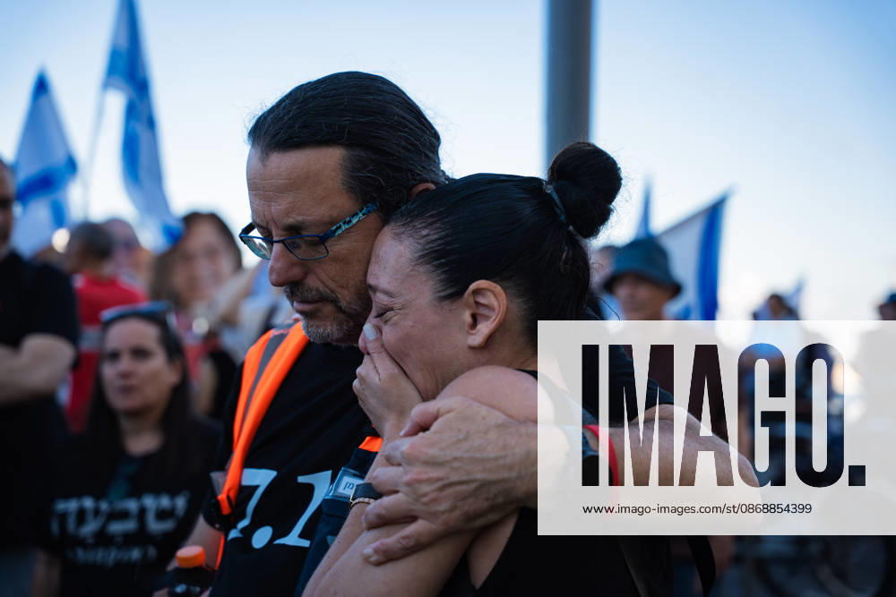 A protester comforts a tearful woman at a protest blaming the Israeli government for responsibility for October 7th on the third anniversary of the massacre. Tel Aviv Israel - ZUMAg280 20261007_znp_g280_004