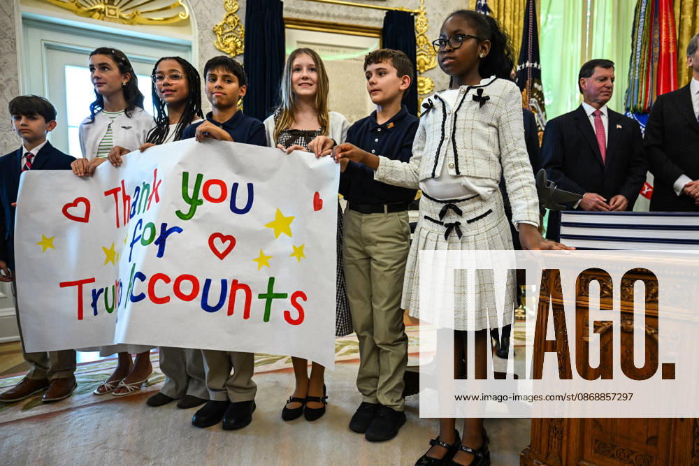 Trump Makes Oval Office Announcement WASHINGTON, DC - OCT. 7: Kids hold up a sign as US President Donald Trump speaks during an announcement on Trump Accounts in the Oval Office on Wednesday, Oct. 7, 2026 at the White House in Washington, D.C. (Photo by Annabelle Gordon Pool For The Washington Post) Washington DC United States