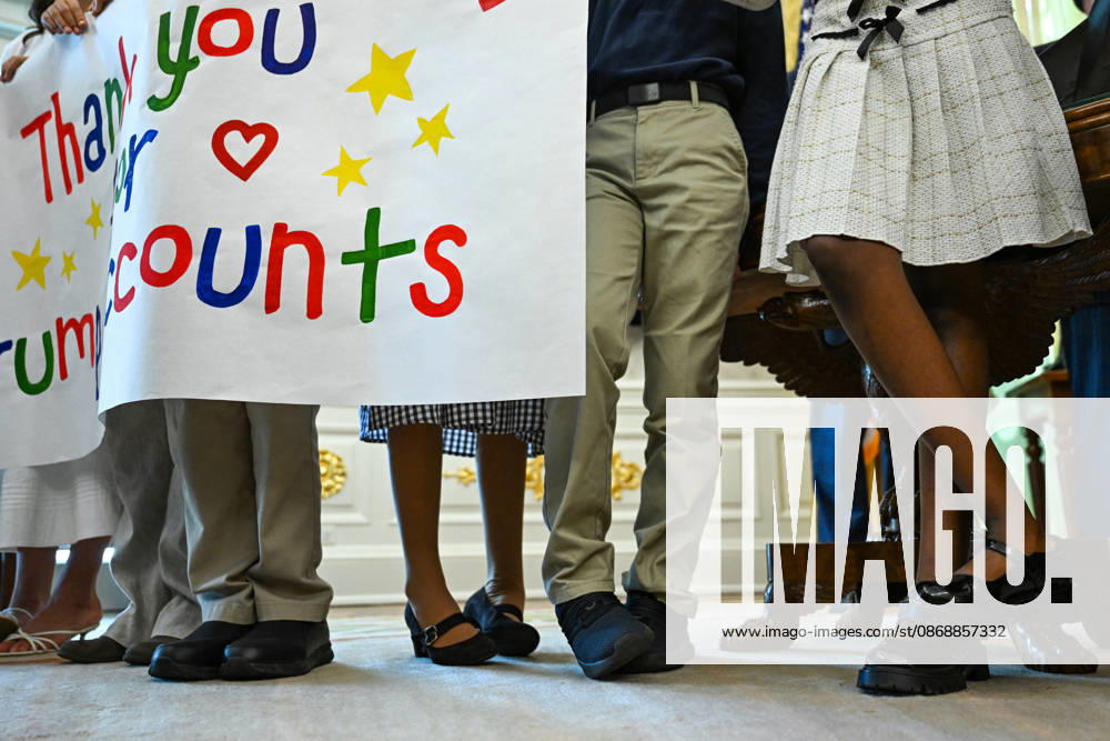 Trump Makes Oval Office Announcement WASHINGTON, DC - OCT. 7: Kids holding a sign shift their feet as US President Donald Trump speaks during an announcement on Trump Accounts in the Oval Office on Wednesday, Oct. 7, 2026 at the White House in Washington, D.C. (Photo by Annabelle Gordon Pool For The Washington Post) Washington DC United States