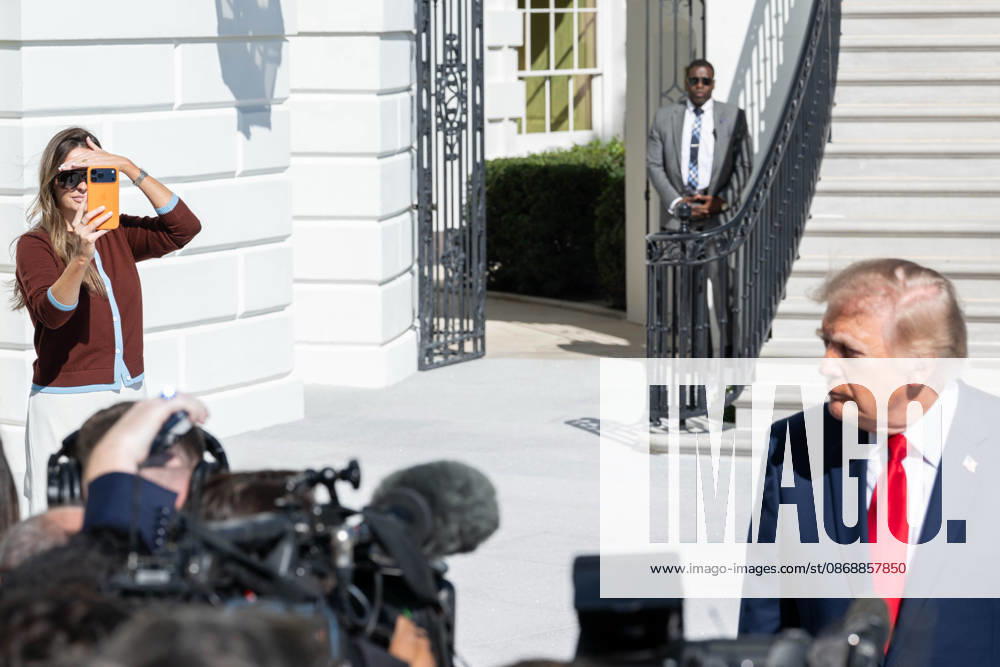 White House Communications Adviser MARGO MARTIN films President DONALD TRUMP as he speaks to reporters on the South Lawn of the White House before departing for San Antonio, Texas. Washington United States - ZUMAk206 20261007_znp_k206_017