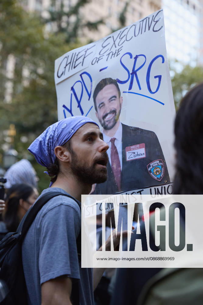 A demonstrator wearing a keffiyeh holds a protest sign during a pro-Palestinian rally at City Hall Park in New York City, New York. New York USA - ZUMAs237 20261007_aap_s237_024
