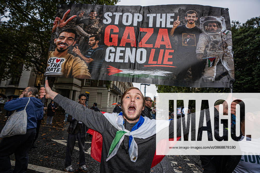 Pro-Israeil counter protestors challenge pro-Palestine demonstrators in London, UK - 7 OCT 2026. A protester seen holding a banner bearing words in white and red colour STOP THE GAZA GENO LIE Pro-Palestine activists from Central London Universities chose the 3rd anniversary of the October 7th attack by Hamas to protest against Israel’s war on Gaza. They clashed en route with pro-Israeli counter protestors. The demonstration was arranged by an inter-uni coalition that includes King’s College and LSE. London United Kingdom