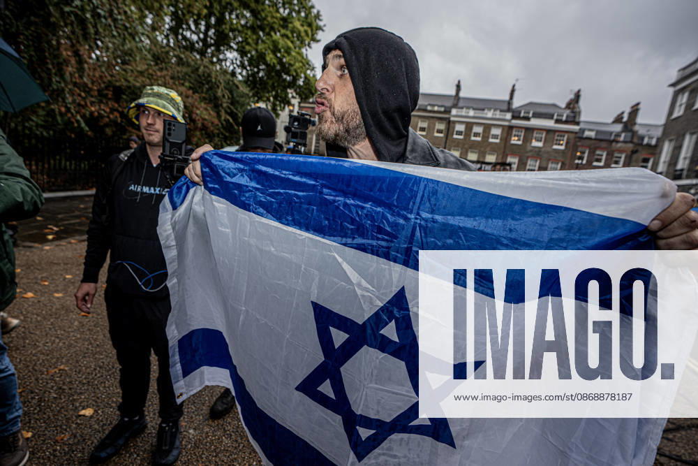 Pro-Israeil counter protestors challenge pro-Palestine demonstrators in London, UK - 7 OCT 2026. An English patriot seen holding a flag (Israeli flag) during the protest . Pro-Palestine activists from Central London Universities chose the 3rd anniversary of the October 7th attack by Hamas to protest against Israel’s war on Gaza. They clashed en route with pro-Israeli counter protestors. The demonstration was arranged by an inter-uni coalition that includes King’s College and LSE. London United Kingdom
