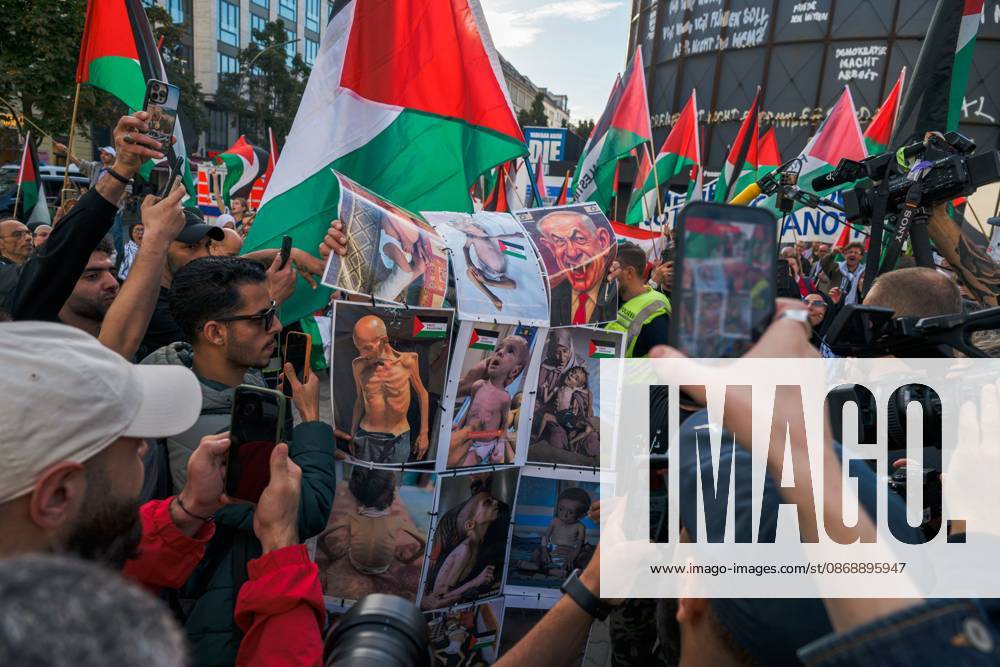 BERLIN, GERMANY, OCTOBER 7, 2026: Demonstrators gather at Checkpoint Charlie in central Berlin to mark three years since the start of the Gaza war. Participants protest against Israelâ€⠢s military actions in Gaza, which they describe as genocide, and express solidarity with Palestinians. Berlin Germany - ZUMAq101 20261007_zna_q101_409