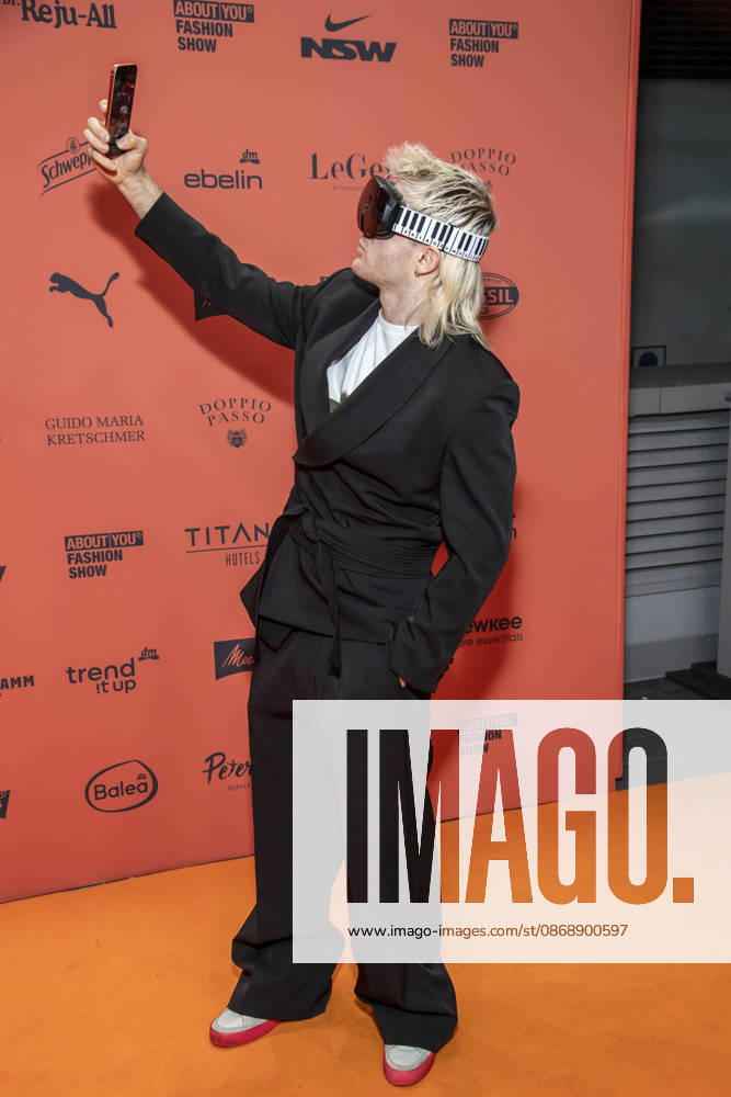 ABB ABOUTYOU Ski Aggu as a guest on the orange carpet at the ABOUT YOU Opera Fashion Show at the Admiralspalast on October 7, 2026, in Berlin, Germany