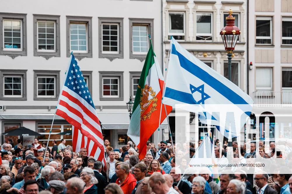 Rally in Düsseldorf marking the anniversary of Hamas’s terrorist attack on Israel on October 7, 2023, and against anti-Semitism; flag, banner, U.S., Iran, the historic Lion and Sun flag, Israel, close-up