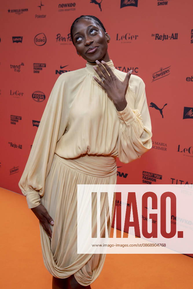 ABB ABOUTYOU Toni Dreher Adenuga as a guest on the Orange Carpet at the ABOUT YOU Opera Fashion Show at the Admiralspalast on October 7, 2026, in Berlin, Germany