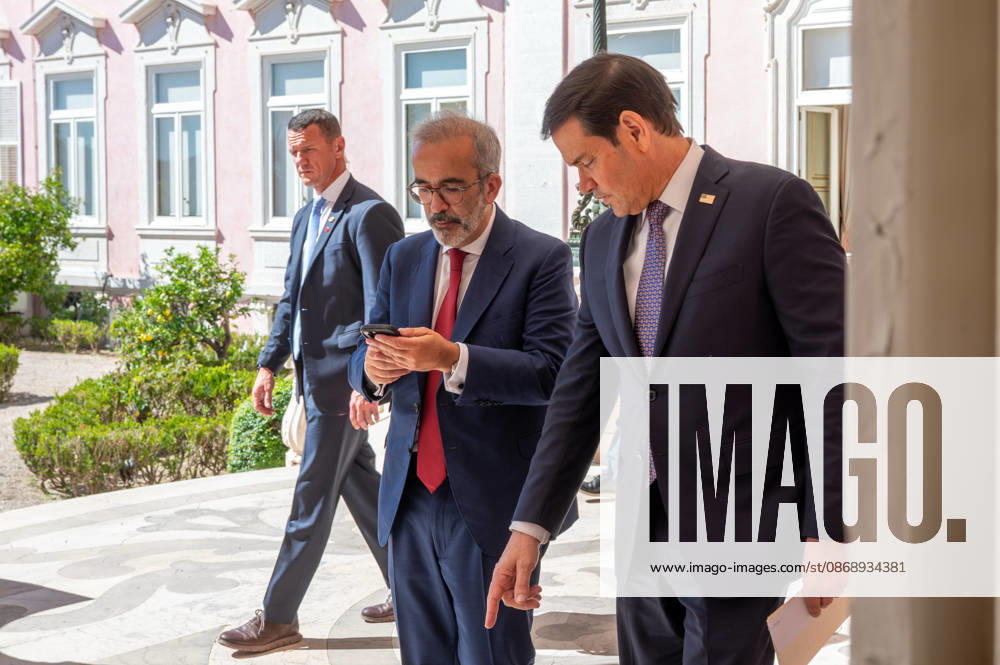 U.S. Secretary of State MARCO RUBIO, right, and Portugal s Minister of State and Foreign Affairs PAULO RANGEL enter their joint press conference at the Palacio das Necessidades in Lisbon, Portugal, on October 8, 2026. RANGEL checks his phone as the two officials arrive for the media appearance following their bilateral meeting. Lisbon Portugal - ZUMAr238 20261008_zip_r238_005