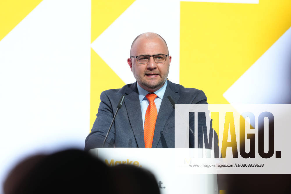 Brand Economy Day 2026: Author and speaker Stefan Kolev on stage during his keynote address at Brand Economy Day 2026, Berlin, October 8, 2026, Berlin, Berlin, Germany