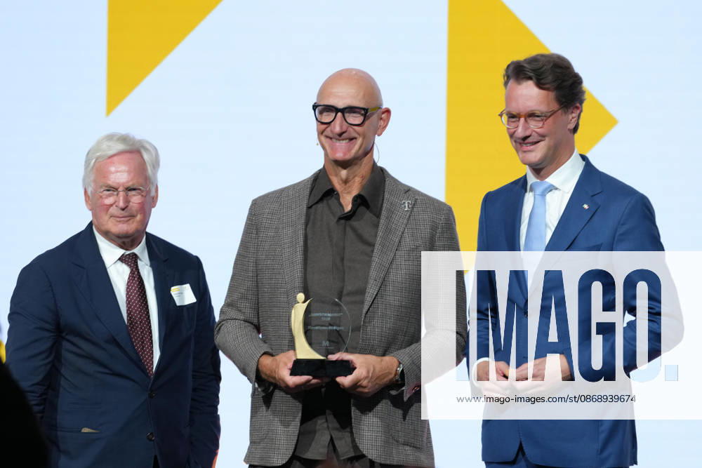 Brand Economy Day 2026: Franz Peter Falke on stage with Tim Hoettges, CEO of Telekom and winner of the Human Brand award, and Hendrik Wuest, Minister President of North Rhine-Westphalia, at Brand Economy Day 2026, Berlin, October 8, 2026, Berlin, Berlin, Germany