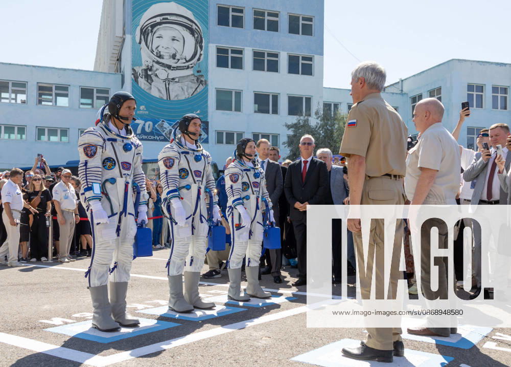Baikonur, Kazakhstan. 14 July, 2026. NASA astronaut Anil Menon, left, and Roscosmos cosmonauts Pyotr Dubrov and Anna Kikina report to Roscosmos leadership as they depart Building 254 for their Soyuz launch at the Baikonur Cosmodrome, July 14, 2026 in Baikonur, Kazakhstan. Reporting to officials is a Russian launch day tradition. Baikonur Kazakhstan - ZUMAp138 20261008_zaa_p138_031