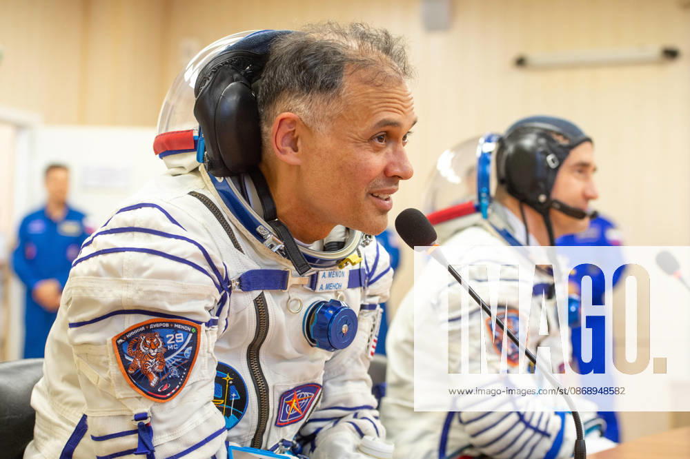 Baikonur, Kazakhstan. 14 July, 2026. NASA astronaut Anil Menon, left, and Roscosmos cosmonaut Pyotr Dubrov talk to family and friends after Sokol suit pressure checks at the Baikonur Cosmodrome, July 14, 2026 in Baikonur, Kazakhstan. The crew launched to the International Space Station later that day. Baikonur Kazakhstan - ZUMAp138 20261008_zaa_p138_033