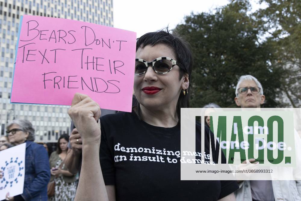 A demonstrator wears a shirt that reads demonizing men is an insult to demons and holds a sign that reads Bears Don t TEXT Their FRIENDS joining hundreds at a rally in Foley Square outside the New York State Supreme Court building in Lower Manhattan under the banner . StopSexualViolence: From the Frat House to the White House. The protest is one of many rallies and campus walkouts around the country demanding justice for Cornell s Jane Doe. New York USA - ZUMAr174 20261008_znp_r174_021