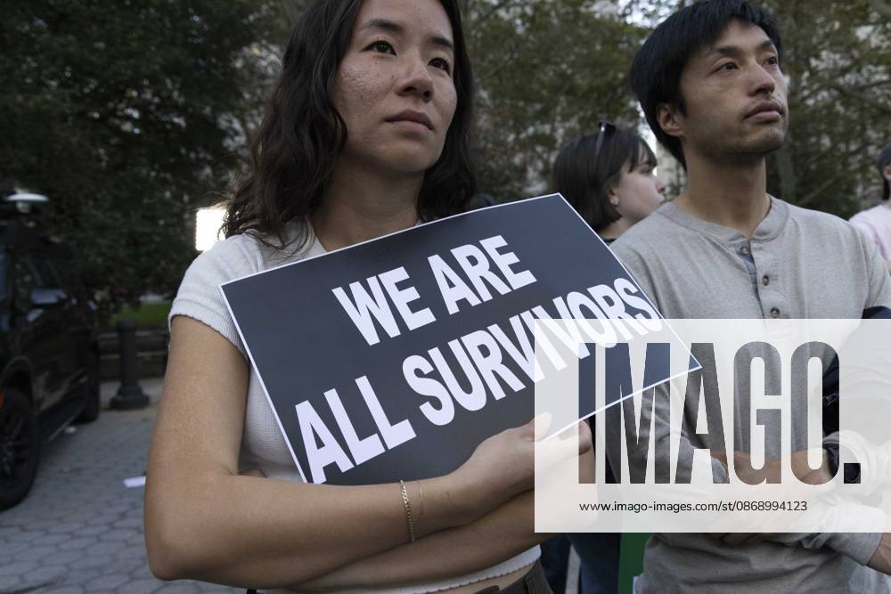 A demonstrator holds a sign that reads WE ARE ALL SURVIVORS joining hundreds at a rally in Foley Square outside the New York State Supreme Court building in Lower Manhattan under the banner . StopSexualViolence: From the Frat House to the White House. The protest is one of many rallies and campus walkouts around the country demanding justice for Cornell s Jane Doe. New York USA - ZUMAr174 20261008_znp_r174_025