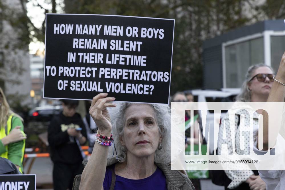 A demonstrator holds a sign that reads HOW MANY MEN OR BOYS REMAIN SILENT IN THEIR LIFETIME TO PROTECT PERPETRATORS OF SEXUAL VIOLENCE? joining hundreds at a rally in Foley Square outside the New York State Supreme Court building in Lower Manhattan under the banner . StopSexualViolence: From the Frat House to the White House. The protest is one of many rallies and campus walkouts around the country demanding justice for Cornell s Jane Doe. New York USA - ZUMAr174 20261008_znp_r174_027