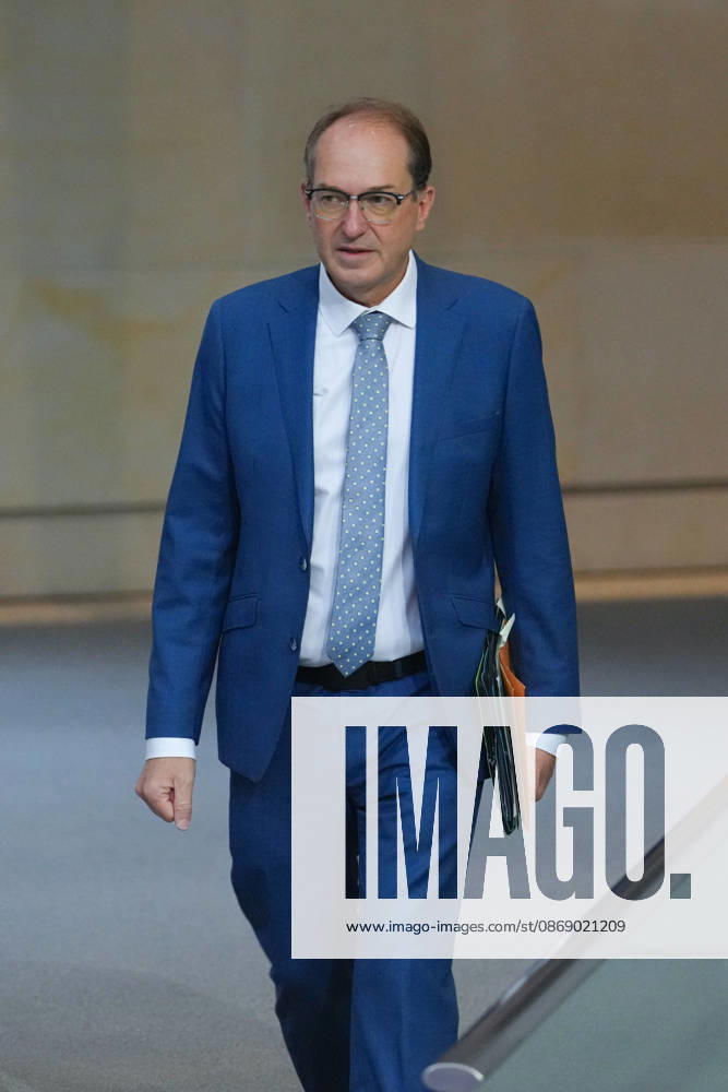 German Bundestag, 100th Plenary Session: Alexander Dobrindt, Federal Minister of the Interior, walks through the chamber toward the government bench with animated facial expressions during the 100th session of the German Bundestag in Berlin, October 9, 2026, Berlin, Berlin, Germany