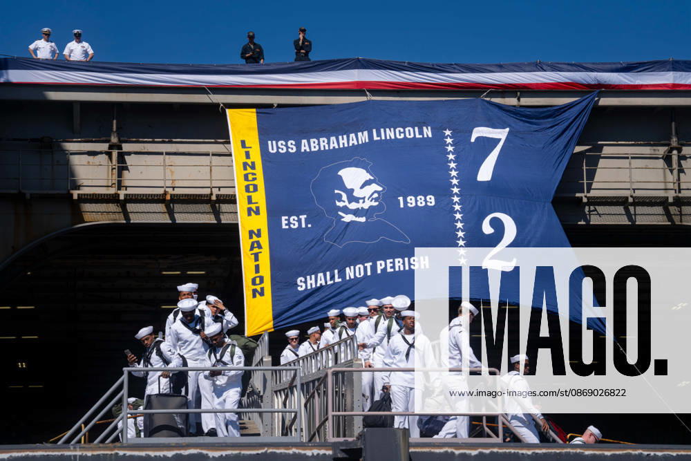 U.S. Navy sailors disembark from the aircraft carrier USS Abraham Lincoln (CVN 72) during its homecoming at Naval Air Station North Island in Coronado, California, on October 8, 2026, following a deployment. A banner bearing the ship s name and the words Shall Not Perish hangs above the gangway. Coronado United States - ZUMAg374 20261008_znp_g374_015