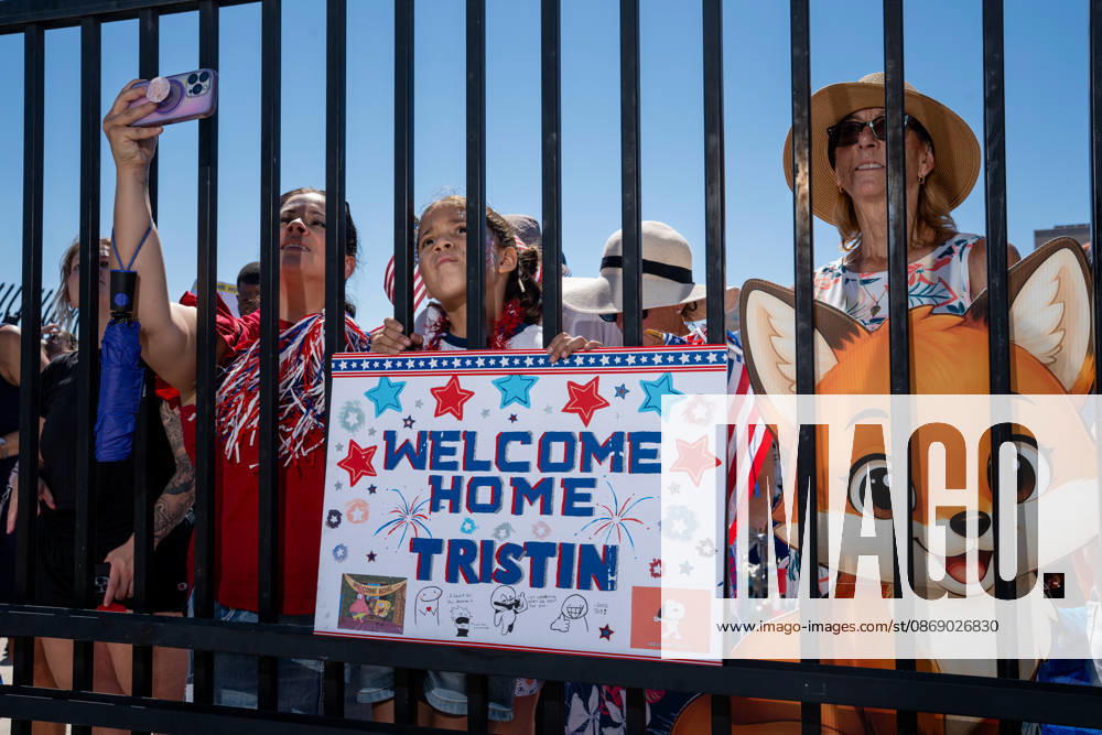 Family members hold a handmade welcome-home sign for sailor Tristin and pose with a character cutout as they await the return of the aircraft carrier USS Abraham Lincoln (CVN 72) at Naval Air Station North Island in Coronado, California, on October 8, 2026, following a deployment. Coronado United States - ZUMAg374 20261008_znp_g374_017