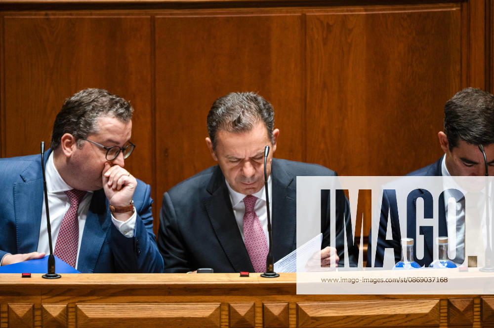 Portuguese Prime Minister LUIS MONTENEGRO, center, reviews a document while seated on the government bench during a parliamentary session at the Assembleia da Republica in Lisbon, Portugal, on October 9, 2026. The sitting includes the fortnightly debate with the prime minister, followed by a preparatory debate for the European Council. Lisbon Portugal - ZUMAr238 20261009_zip_r238_005