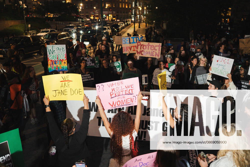Women gather around a banner with signs demanding protection for women. New York United States - ZUMAf193 20261008_znp_f193_014