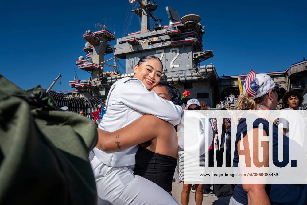 A U.S. Navy sailor embraces a loved one during the homecoming of the USS Abraham Lincoln (CVN 72) at Naval Air Station North Island in Coronado, following the aircraft carrier s scrutinized 322-day deployment. Coronado USA - ZUMAg374 20261008_znp_g374_041