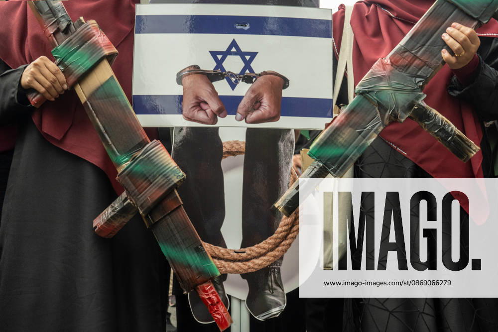 Protesters hold up mockup of depicting Israeli Prime Minister Netanyahu alongside mock cardboard weapons and placard during Global Day of Action: March for Palestine. Kuala Lumpur Malaysia - ZUMAr146 20261009_zap_r146_002