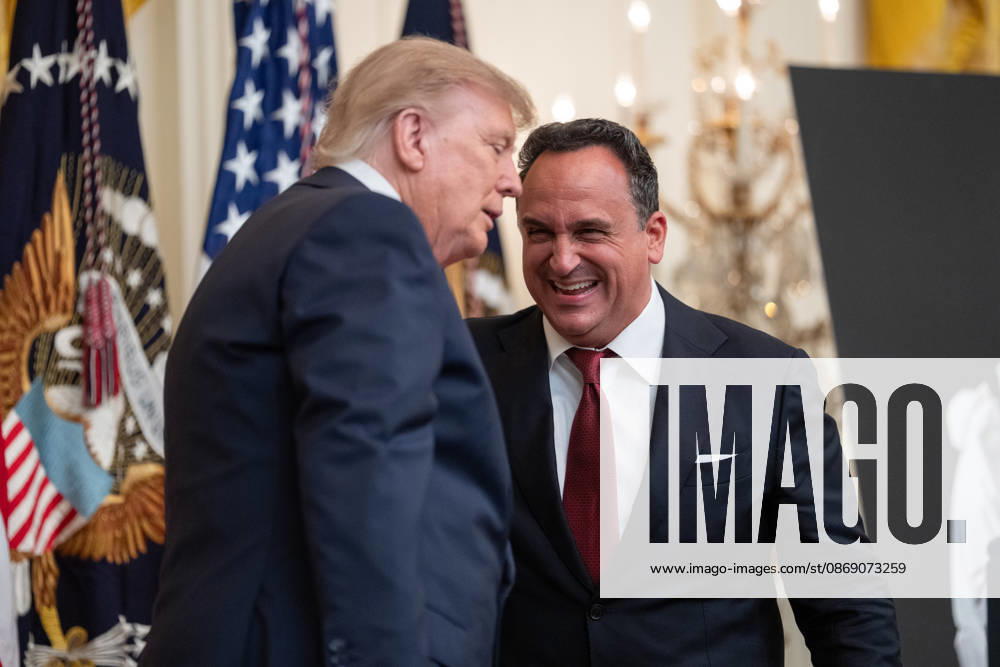 President Donald Trump embraces singer Christopher Macchio during an event in the East Room of the White House in Washington, DC on Friday, Oct. 9, 2026. Trump is hosting a Columbus Day celebration. WASP20261009108 AaronxSchwartz