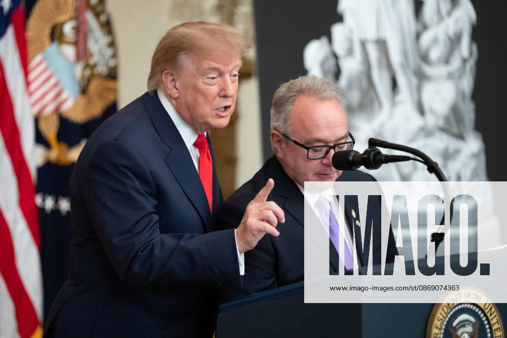 Brett Rugo, founder of Rugo Stone which constructed a helipad on the South Lawn, stands with President Donald Trump salutes during an event in the East Room of the White House in Washington, DC on Friday, Oct. 9, 2026. Trump is hosting a Columbus Day celebration. WASP20261009118 AaronxSchwartz