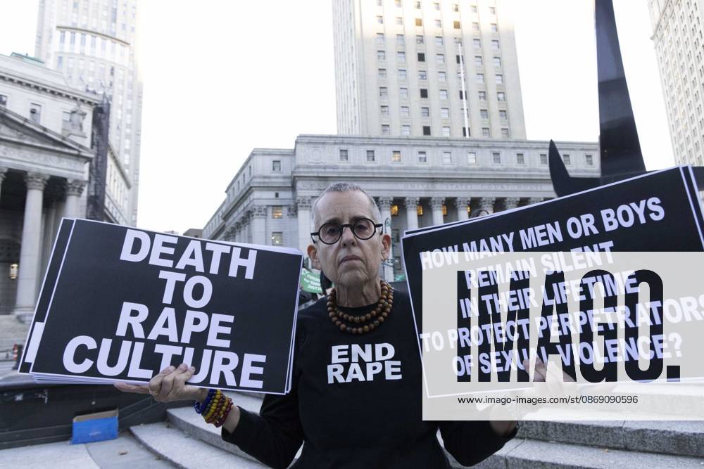A demonstrator wears a shirt that reads END RAPE and holds signs that read DEATH TO RAPE CULTURE HOW MANY MEN OR BOYS REMAIN SILENT IN THEIR LIFETIME TO PROTECT PERPETRATORS OF SEXUAL VIOLENCE? joining hundreds at a rally in Foley Square outside the New York State Supreme Court building in Lower Manhattan under the banner . StopSexualViolence: From the Frat House to the White House. The protest is one of many rallies and campus walkouts around the country demanding justice for Cornell s Jane Doe. New York USA - ZUMAr174 20261008_znp_r174_055