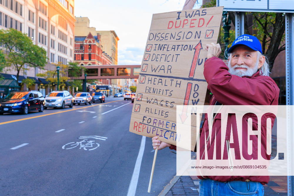 A man who identifies as a former republican holds up his sign during the protest against the Trump rally held at the Oncenter. Syracuse USA - ZUMAh195 20261009_znp_h195_006